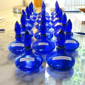 blue perfume bottles filled with simple fragrances that can be mixed and matched. Bottles are shaped like a flame
