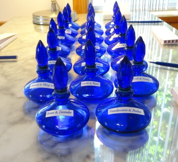 blue perfume bottles filled with simple fragrances that can be mixed and matched. Bottles are shaped like a flame