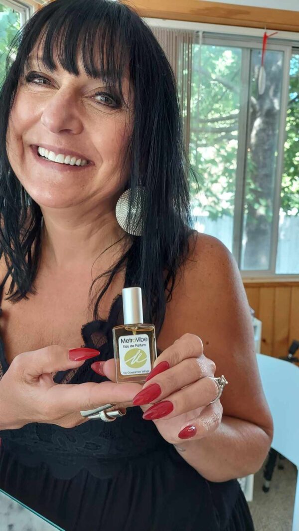Cindi from metropolitan spa with bottle of custom fragrance